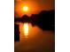 Picturesque sunset view reflecting on the serene water, offering a tranquil ambiance at 3415 Holly Springs Dr, Hernando Beach, FL 34607