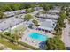 Aerial view of community featuring lush landscaping, a pool, shuffleboard and covered seating at 4217 Terrapin Pl # 4217, New Port Richey, FL 34652
