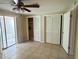 Bedroom featuring sliding doors to sunroom and double closets at 4217 Terrapin Pl # 4217, New Port Richey, FL 34652