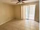 Light-filled bedroom with tile flooring, ceiling fan, and sliding glass door access at 4217 Terrapin Pl # 4217, New Port Richey, FL 34652