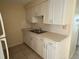 Functional kitchen features white cabinets, double sink, and ample counter space at 4217 Terrapin Pl # 4217, New Port Richey, FL 34652