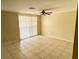 Bright living room featuring tile flooring, ceiling fan, and sliding glass doors at 4217 Terrapin Pl # 4217, New Port Richey, FL 34652