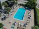 Aerial view of a pool area with lounge chairs, tables, and tropical landscaping at 4217 Terrapin Pl # 4217, New Port Richey, FL 34652