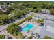 Aerial view of a community pool surrounded by lush landscaping and seating at 4217 Terrapin Pl # 4217, New Port Richey, FL 34652