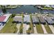 Aerial view of waterfront homes with docks and boat lifts on a sunny day in a canal community at 4400 Floramar Ter, New Port Richey, FL 34652