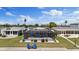 A screened-in pool is surrounded by landscaping in a backyard of a canal front home at 4400 Floramar Ter, New Port Richey, FL 34652