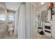 Compact bathroom with shower, toilet, sink, and storage cabinet at 4400 Floramar Ter, New Port Richey, FL 34652