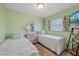 Cozy guest bedroom with two twin beds, a dresser, and nautical-themed decor at 4400 Floramar Ter, New Port Richey, FL 34652