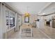 Dining room with natural light, stylish light fixture and view of kitchen and outdoor pool area at 4400 Floramar Ter, New Port Richey, FL 34652