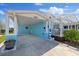Charming coastal home with a blue exterior, carport, and quaint front porch at 4400 Floramar Ter, New Port Richey, FL 34652