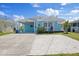 Charming coastal-style home with a front porch and a spacious driveway, perfect for relaxing at 4400 Floramar Ter, New Port Richey, FL 34652