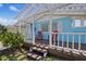 Charming front porch features a pergola, seating, and blue exterior paint at 4400 Floramar Ter, New Port Richey, FL 34652