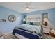 Light and airy main bedroom with blue walls, stylish decor, and ample natural light at 4400 Floramar Ter, New Port Richey, FL 34652