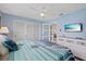 Spacious main bedroom with a large bed, a ceiling fan, and access to the rest of the house at 4400 Floramar Ter, New Port Richey, FL 34652