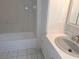 Bright bathroom features tiled walls, tub, and white vanity at 4503 Sheffield Rd, Land O Lakes, FL 34639