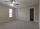 Bedroom features plush carpeting, ceiling fan, and ample closet space at 4503 Sheffield Rd, Land O Lakes, FL 34639