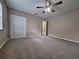 Spacious bedroom featuring a ceiling fan, neutral walls, and large closet for ample storage at 4503 Sheffield Rd, Land O Lakes, FL 34639