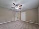 Large bedroom features plush carpeting, ceiling fan, and ample closet space at 4503 Sheffield Rd, Land O Lakes, FL 34639