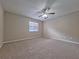 Bedroom features plush carpeting, a ceiling fan, and a window at 4503 Sheffield Rd, Land O Lakes, FL 34639