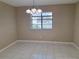 Dining room featuring tile flooring, a chandelier, and natural light streaming through the window at 4503 Sheffield Rd, Land O Lakes, FL 34639