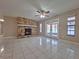 Cozy living area with tile floors, a stone fireplace, and access to the outdoors through glass doors at 4503 Sheffield Rd, Land O Lakes, FL 34639