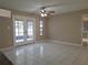 Inviting living room with tile floors, ceiling fan, and double doors leading to the outdoor patio at 4503 Sheffield Rd, Land O Lakes, FL 34639