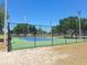 Outdoor community tennis court features new surface, lighting and perimeter fencing at 4503 Sheffield Rd, Land O Lakes, FL 34639