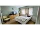 Inviting bedroom with a window view and complete with a comfortable chair and dresser at 4548 Somerset Pl, New Port Richey, FL 34652
