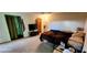 Bright bedroom featuring cozy carpet, a ceiling fan, and a convenient en-suite bathroom at 4548 Somerset Pl, New Port Richey, FL 34652