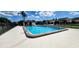 Large, in-ground community pool with inviting blue water and a convenient cabana nearby at 4548 Somerset Pl, New Port Richey, FL 34652