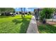 Manicured front lawn and sidewalk lead to residences with attached garages and well maintained landscaping at 4548 Somerset Pl, New Port Richey, FL 34652