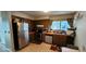 Functional kitchen with stainless steel refrigerator and a window providing natural light at 4548 Somerset Pl, New Port Richey, FL 34652