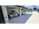 Community pool has a covered outdoor sitting area with tables, chairs and pool rules sign at 4548 Somerset Pl, New Port Richey, FL 34652
