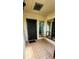 Inviting porch with tiled flooring, a secure front door, and well-placed windows for natural light at 4548 Somerset Pl, New Port Richey, FL 34652