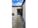 Pavered walkway leading to the gated entrance, with an adjacent air conditioner at 4548 Somerset Pl, New Port Richey, FL 34652