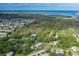 Aerial view of a secluded property with an in-ground pool bordered by a natural green canopy and coastal waterways at 4573 Ontario Dr, New Port Richey, FL 34652