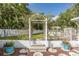 Picture shows backyard patio with an decorative arbor, stepping stones, and potted plants at 4573 Ontario Dr, New Port Richey, FL 34652