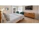Bright bedroom with outdoor access, mounted TV, dresser and comfortable furniture at 4731 Egret Rd, Venice, FL 34293
