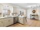 Updated kitchen with stainless steel dishwasher, tile backsplash, and island seating at 4731 Egret Rd, Venice, FL 34293