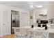 Bright kitchen featuring stainless steel appliances, white cabinets, and bar seating at 4731 Egret Rd, Venice, FL 34293