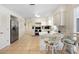 Open concept kitchen boasts stainless steel appliances, white cabinets, and barstool seating at 4731 Egret Rd, Venice, FL 34293