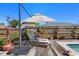 Outdoor patio and pool area with patio furniture, an umbrella, and lush landscaping in the backyard at 4731 Egret Rd, Venice, FL 34293