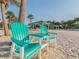 Beautiful beach scene featuring lounge chairs on the sand, palm trees, and scenic waterfront views at 4945 Getner St, New Port Richey, FL 34652