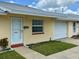 Inviting home exterior featuring a garage, well-kept lawn, and walkway leading to the front door at 4945 Getner St, New Port Richey, FL 34652