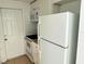 Compact kitchen featuring modern appliances, efficient storage, and a convenient door to the outside at 4945 Getner St, New Port Richey, FL 34652