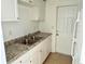 Functional kitchen featuring a stainless steel sink, ample counter space, and a convenient door to the outside at 4945 Getner St, New Port Richey, FL 34652