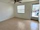 Bright living room featuring tile floors, a ceiling fan and natural light streaming through the window at 4945 Getner St, New Port Richey, FL 34652
