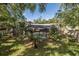 The tranquil backyard includes a screened pool, creating a peaceful outdoor retreat at 512 Winding Willow Dr, Palm Harbor, FL 34683