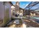 Backyard including a grill, storage and access to the screened-in pool area at 512 Winding Willow Dr, Palm Harbor, FL 34683