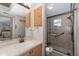 Bathroom featuring a vanity and glass door shower, providing convenience and style at 512 Winding Willow Dr, Palm Harbor, FL 34683